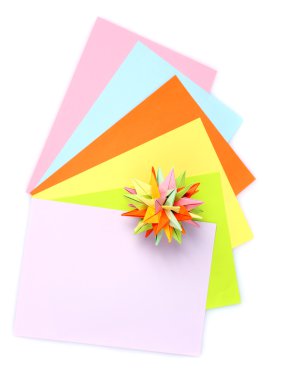 Colorfull origami kusudama and bright paper isolated on white clipart