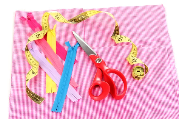 Scissors, zips and measuring tape on fabric isolated on white — Stock Photo, Image