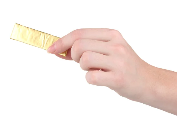Goma de mascar envuelta en lámina dorada en mano aislada en blanco — Foto de Stock