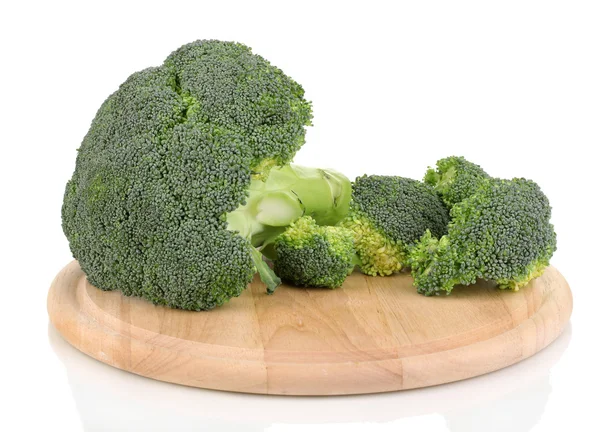 Broccoli on wooden chopping board isolated on white — Stock Photo, Image