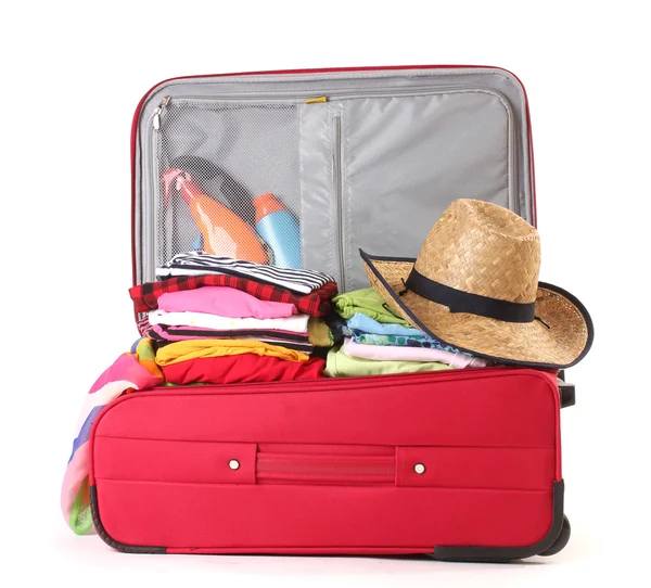 Open red suitcase with clothing isolated on a white — Stock Photo, Image