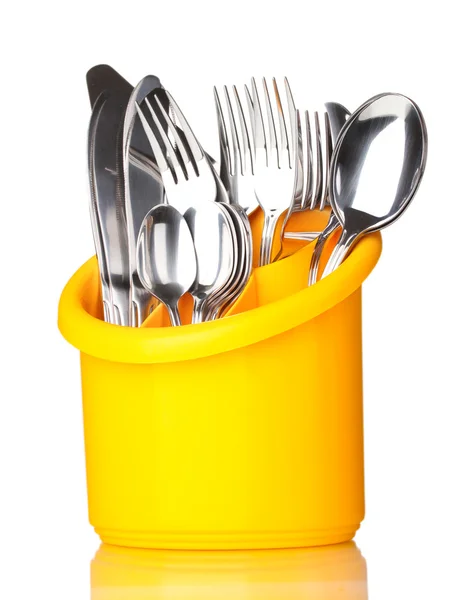 stock image Kitchen cutlery, knives, forks and spoons in yellow stand isolated on white