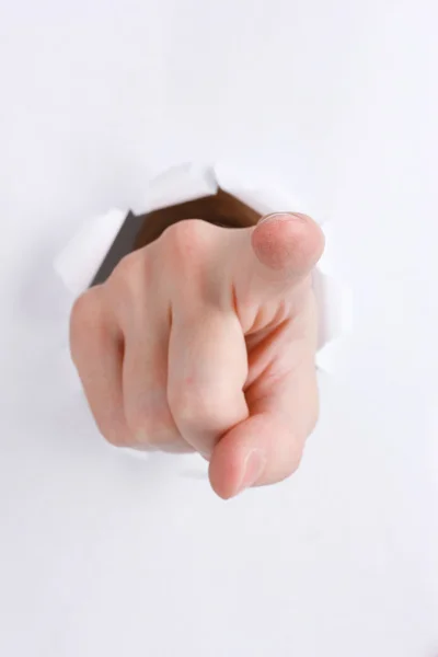 Pointing hand breaking through the paper — Stock Photo, Image