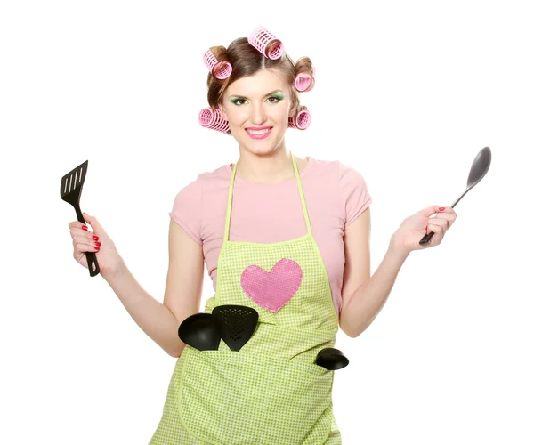 Красивая молодая домохозяйка с кухонной утварью изолированы на белом — стоковое фото
