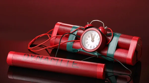 Timebomb made of dynamite on red background — Stock Photo, Image