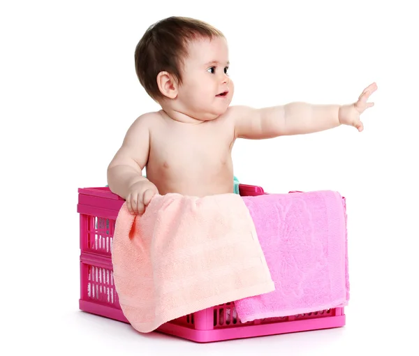 Roztomilá holčička v prádelním koši, izolované na bílém — Stock fotografie