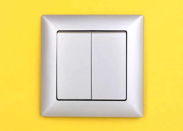 黄色の背景に現代的な光スイッチ — ストック写真