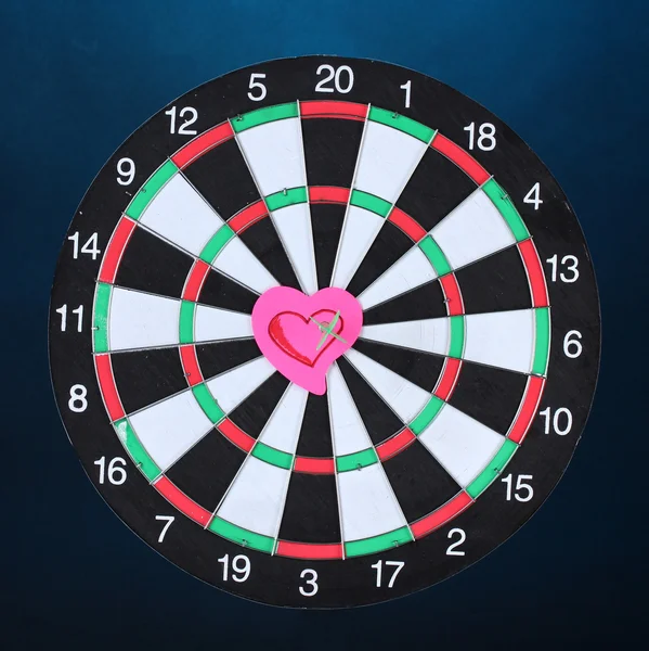 Darts with stickers depicting the life values on colorful background. The darts hit the target — Stock Photo, Image