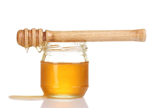 Jar of honey and wooden drizzler isolated on white Stock Image