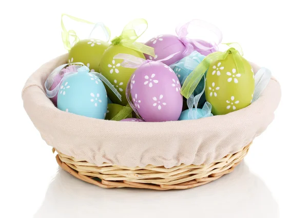 Colorful easter eggs in basket isolated on white — Stock Photo, Image
