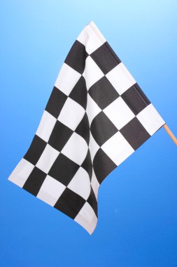 Checkered finish flag on blue background clipart