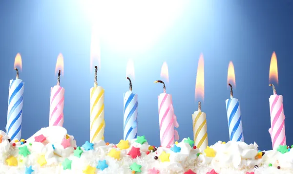 Belas velas de aniversário no fundo azul — Fotografia de Stock