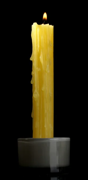 Yellow candle on black background — Stock Photo, Image