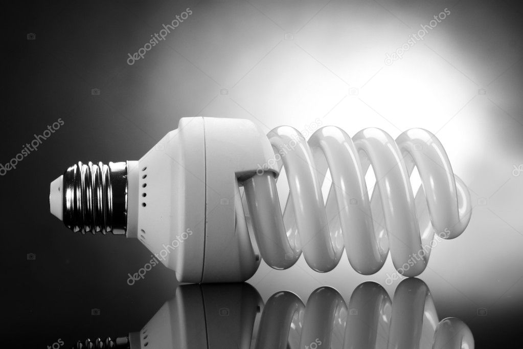 Energy saving lamp on grey background