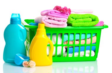 Detergents and towels in green plastic basket isolated on white clipart