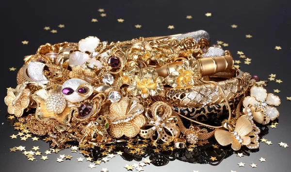Beautiful golden jewelry on grey background — Stock Photo, Image