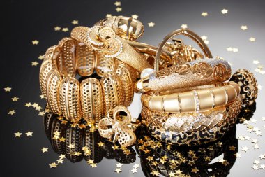 Beautiful golden jewelry on grey background clipart