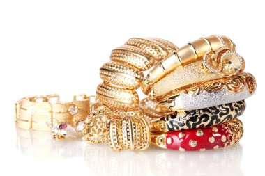 Beautiful golden bracelets isolated on white clipart