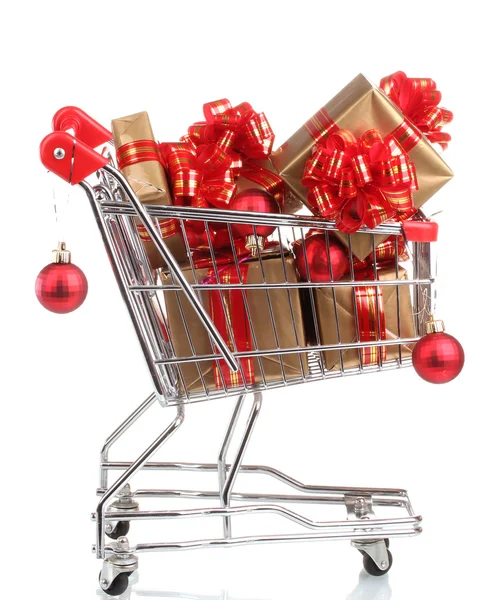 Beautiful golden gifts with red ribbon and Christmas balls in shopping cart isolated on white — Stock Photo, Image