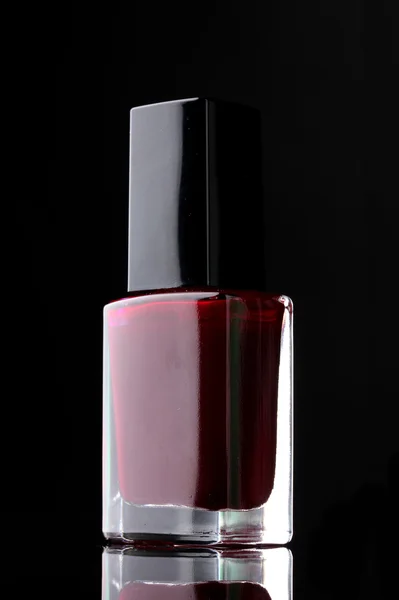 Red nail polish on black background — Stock Photo, Image