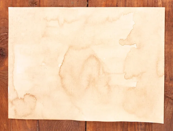 Old paper on wooden table — Stock Photo, Image