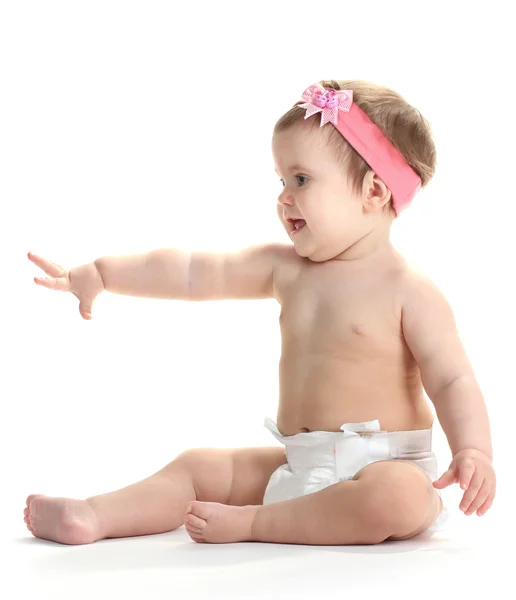 Bonito bebê menina sentado e puxando a mão isolada no branco — Fotografia de Stock