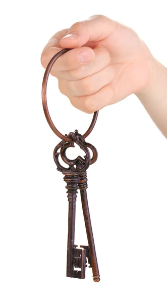 Woman's hand holding a bunch of antique keys on white background — Stock Photo, Image