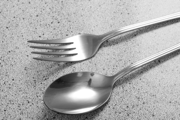 Vidlička a lžíce na mramorový stůl — Stock fotografie