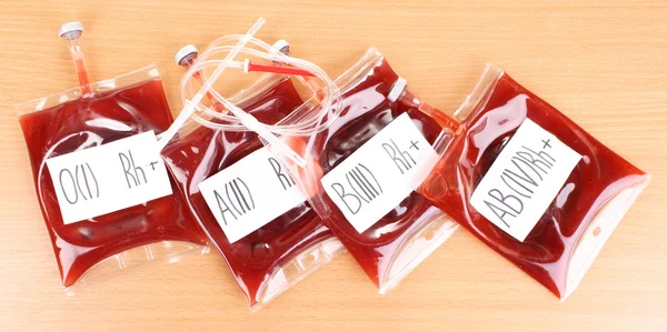 Bags of blood and infusion on wooden background — Stock Photo, Image
