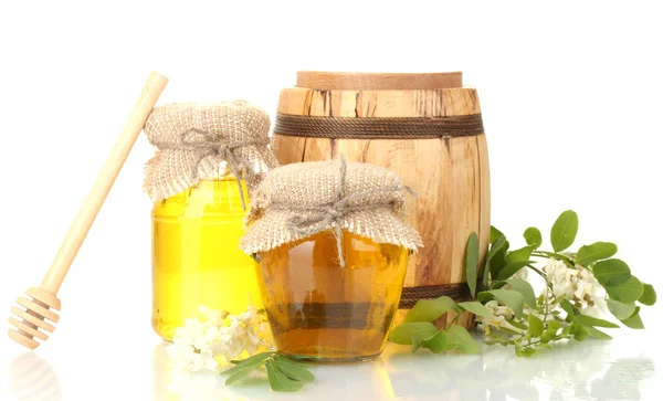Sweet honey in barrel and jars with acacia flowers isolated on white — Stock Photo, Image