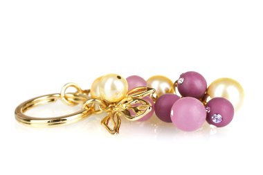 Beautiful golden keychain with precious stones isolated on white clipart