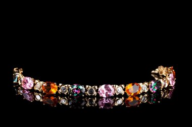 Beautiful bracelet with precious stones on black background clipart