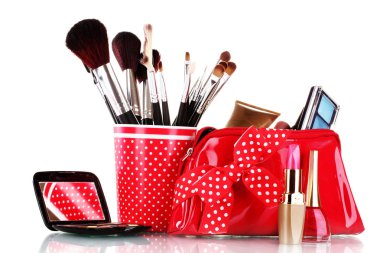 Red glass with brushes and makeup bag with cosmetics isolated on white clipart