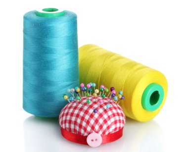 Bobbins of thread with pinheads in pin-cushion isolated on white clipart