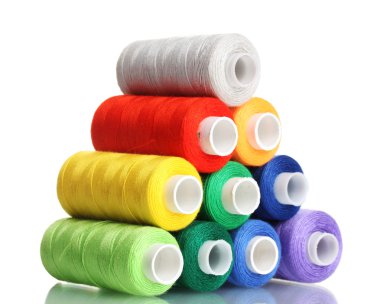 Pyramid of many-coloured bobbins of thread isolated on white clipart