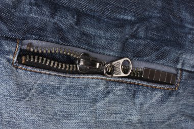 Zipper on dark jeans closeup