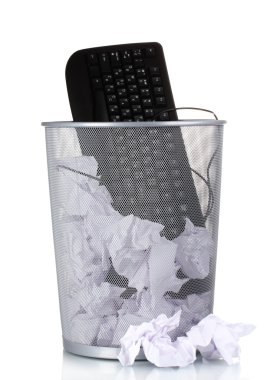 Old PC keyboard and paper in metal trash bin isolated on white clipart