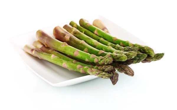 Delicious fresh asparagus on a plate isolated on white — Stock Photo, Image