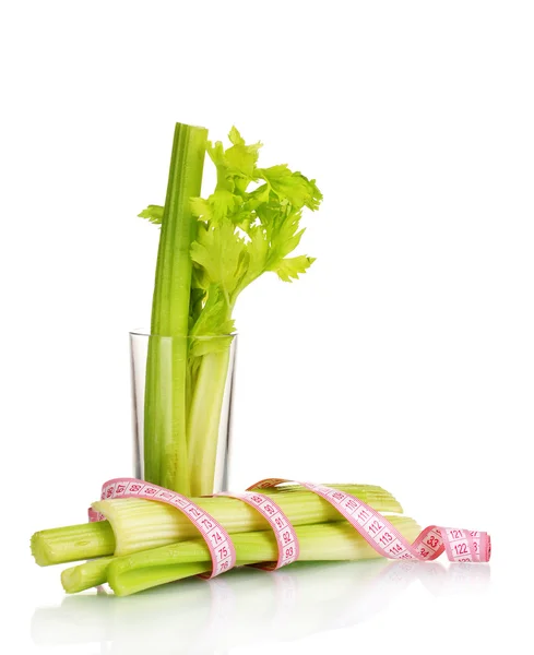Fresh green celery in the glass and measuring tape isolated on white — Stock Photo, Image