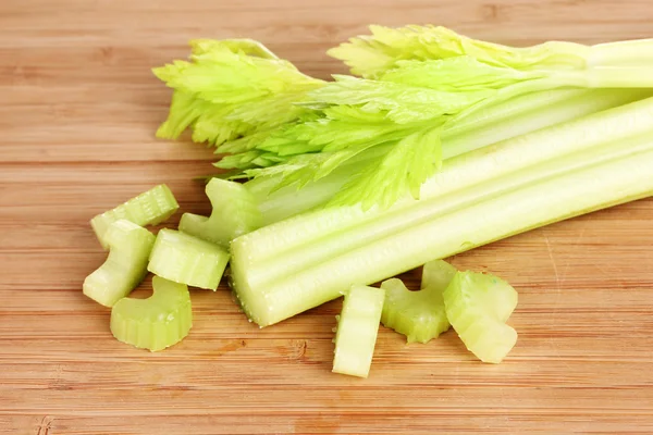 Fresh slised green celery on wooden background — Stock Photo, Image
