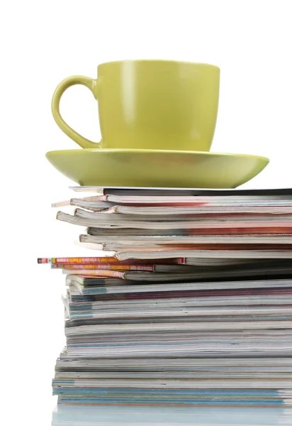 stock image Stack of magazines and cup isolated on white