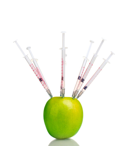 Green apple and syringes isolated on white