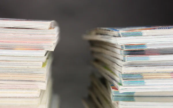 Stacks of magazines on gray background — Stock Photo, Image