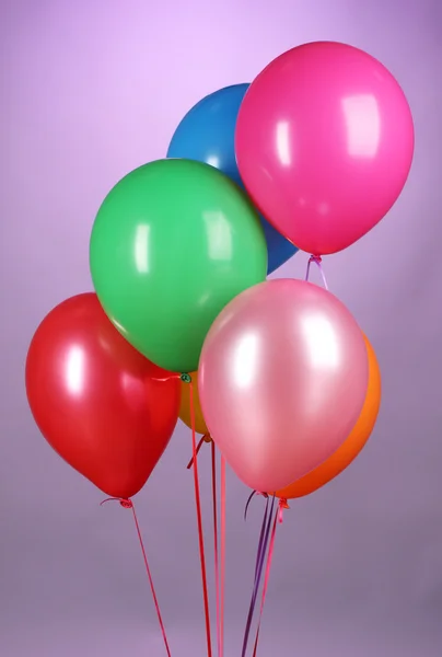 Bright balloons on purole background — Stock Photo, Image