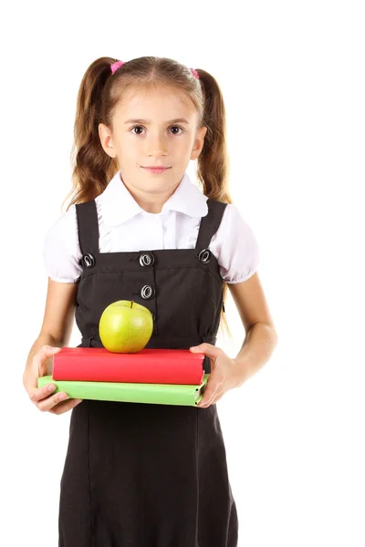 Hermosa niña en uniforme escolar, libros y manzana aislada en blanco —  Fotos de Stock