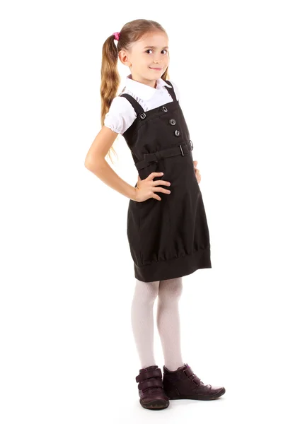 Beautiful little girl in school uniform isolated on white — Stock Photo, Image