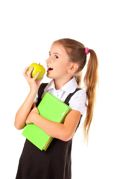Beautiful little girl in school uniform, book and apple isolated on white — Stock Photo, Image
