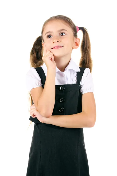 Красивая маленькая девочка в школьной форме изолированы на белом — стоковое фото