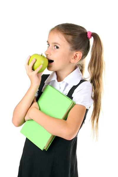 Hermosa niña en uniforme escolar, libro y manzana aislado en blanco —  Fotos de Stock