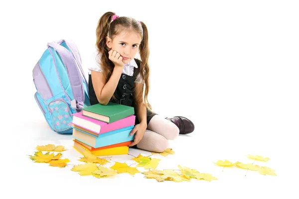 Krásná holčička, knihy a batoh izolované na bílém — Stock fotografie